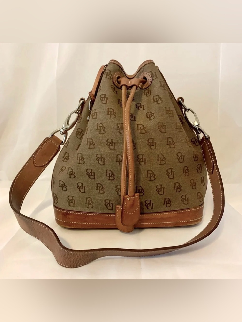 a vintage Dooney & Bourke monogram canvas drawstring bucket bag
